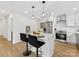 Modern kitchen with white cabinetry, stainless steel appliances, and a center island with bar stool seating at 2600 Alleghany St # 10, Charlotte, NC 28208