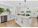 Modern kitchen with white cabinetry, stainless steel appliances, and a center island with bar stool seating at 2600 Alleghany St # 10, Charlotte, NC 28208