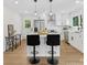 Modern kitchen with white cabinetry, stainless steel appliances, and a center island with bar stool seating at 2600 Alleghany St # 10, Charlotte, NC 28208