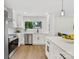 Modern kitchen with white cabinetry, stainless steel appliances, and a center island with bar stool seating at 2600 Alleghany St # 10, Charlotte, NC 28208