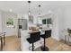 Modern kitchen with white cabinetry, stainless steel appliances, and a center island with bar stool seating at 2600 Alleghany St # 10, Charlotte, NC 28208