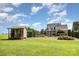Expansive backyard featuring a charming shed and beautiful landscaping with a black fence surrounding the area at 3068 Green Acres Ln, Claremont, NC 28610