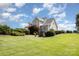 Large backyard featuring mature trees, lush green lawn, and landscaping at 3068 Green Acres Ln, Claremont, NC 28610