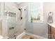 An updated bathroom shows a glass enclosed shower and a bright window at 3068 Green Acres Ln, Claremont, NC 28610