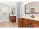 The bathroom shows two wooden vanities, large mirrors, and neutral tiling at 3068 Green Acres Ln, Claremont, NC 28610