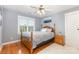 Bedroom featuring hardwood floors, a wooden bed frame, and natural light at 3068 Green Acres Ln, Claremont, NC 28610