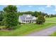Beautiful two-story home featuring a manicured lawn and mature trees at 3068 Green Acres Ln, Claremont, NC 28610