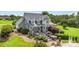 Well-manicured backyard with a deck, hot tub, and lush landscaping at 3068 Green Acres Ln, Claremont, NC 28610