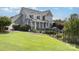 Exterior view of a two-story home with a deck, a grill, and lush landscaping at 3068 Green Acres Ln, Claremont, NC 28610
