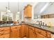 The kitchen features granite countertops, wooden cabinets, stainless steel sink, and hanging pendant lights at 3068 Green Acres Ln, Claremont, NC 28610