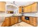Lovely kitchen with wooden cabinetry, granite countertops, stainless steel appliances and tiled backsplash at 3068 Green Acres Ln, Claremont, NC 28610