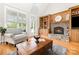Cozy living room with stone fireplace, built-in shelves, hardwood floors and lots of natural light at 3068 Green Acres Ln, Claremont, NC 28610
