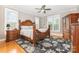 A main bedroom shows the primary bed with wooden floors, light walls, and bright windows at 3068 Green Acres Ln, Claremont, NC 28610