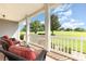 Inviting front porch features comfortable seating and picturesque views of manicured front yard at 3068 Green Acres Ln, Claremont, NC 28610