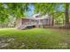 Expansive backyard features a large deck, wood fence, and mature trees at 3092 Hitching Post Ln, Rock Hill, SC 29732