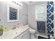 Bathroom featuring a well-lit mirror and stylish blue patterned shower curtain at 3092 Hitching Post Ln, Rock Hill, SC 29732