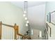 View of the foyer from the staircase highlighting the front door and decor at 3092 Hitching Post Ln, Rock Hill, SC 29732