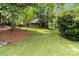 Large grassy front yard with shade trees leading up to the covered front porch of the home at 3092 Hitching Post Ln, Rock Hill, SC 29732