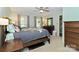 Spacious main bedroom with a ceiling fan, two windows, carpet flooring, and ensuite bathroom at 3092 Hitching Post Ln, Rock Hill, SC 29732