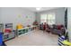Spacious playroom with carpeted floors, a large window and plenty of space for activities at 3092 Hitching Post Ln, Rock Hill, SC 29732