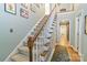 Staircase with carpeted steps and a wood railing leading to the upper level at 3092 Hitching Post Ln, Rock Hill, SC 29732
