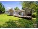 Back exterior with wooden deck and green grass at 322 Cottonwood Park Dr, Charlotte, NC 28214