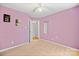 Spacious bedroom featuring neutral carpet and lilac walls with motivational art at 322 Cottonwood Park Dr, Charlotte, NC 28214