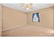 Cozy bedroom featuring neutral carpet, a ceiling fan, and a window with blue curtains at 322 Cottonwood Park Dr, Charlotte, NC 28214