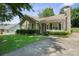Charming single-story home with well-manicured lawn and cozy front porch with white picket fence at 322 Cottonwood Park Dr, Charlotte, NC 28214