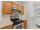Kitchen with white countertops, wood cabinets, and stainless steel microwave and oven at 322 Cottonwood Park Dr, Charlotte, NC 28214