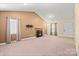Spacious living room with neutral carpet, fireplace, and ample natural light through sliding windows at 322 Cottonwood Park Dr, Charlotte, NC 28214