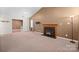 Spacious living room with neutral carpet, fireplace, and ample natural light through sliding windows at 322 Cottonwood Park Dr, Charlotte, NC 28214