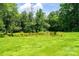 Large backyard area with a pond and lots of green grass and trees surrounding the pond at 3659 Vashti Rd, Taylorsville, NC 28681