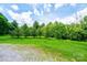 Expansive backyard with lush green lawn and mature trees provides an open, serene space at 3659 Vashti Rd, Taylorsville, NC 28681