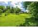A charming home sits nestled in a large lush green yard with mature trees at 3659 Vashti Rd, Taylorsville, NC 28681