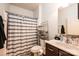 Bathroom featuring a shower with striped curtain, toilet, sink and chrome shelving at 3659 Vashti Rd, Taylorsville, NC 28681