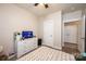 Neutral bedroom with a TV, dresser, ceiling fan, and a door to a large closet at 3659 Vashti Rd, Taylorsville, NC 28681