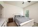 Neutral bedroom with a window, bed with gray linens, and wooden dresser at 3659 Vashti Rd, Taylorsville, NC 28681