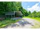 Large carport with ample parking space and storage, situated in a wooded area at 3659 Vashti Rd, Taylorsville, NC 28681