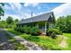 Charming home surrounded by greenery, featuring a stone driveway and covered porch at 3659 Vashti Rd, Taylorsville, NC 28681