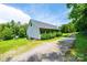 Exterior angle of home with gravel driveway surrounded by well-maintained landscaping at 3659 Vashti Rd, Taylorsville, NC 28681