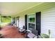 Cozy front porch featuring comfortable seating and a view of the home's lush surroundings at 3659 Vashti Rd, Taylorsville, NC 28681