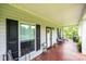Welcoming front porch with seating, wood floors, and a decorative front door offers outdoor relaxation at 3659 Vashti Rd, Taylorsville, NC 28681