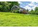Single-Gathering home on a large grassy lot with a wooden deck and trees at 3659 Vashti Rd, Taylorsville, NC 28681
