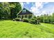 A single-Gathering home sits on a lot with manicured landscaping and a cozy deck at 3659 Vashti Rd, Taylorsville, NC 28681