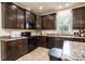 Well-equipped kitchen with black appliances, dark wood cabinets, and ample counter space for meal preparation at 3659 Vashti Rd, Taylorsville, NC 28681