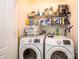 Bright laundry room with a side-by-side washer and dryer under a wire rack for storage at 3659 Vashti Rd, Taylorsville, NC 28681