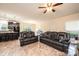 Open concept living area with leather furniture, ceiling fan, and a view into the kitchen and dining spaces at 3659 Vashti Rd, Taylorsville, NC 28681