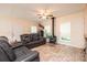 Inviting living room showcasing a wood-burning stove, comfortable seating, and natural light from the surrounding windows at 3659 Vashti Rd, Taylorsville, NC 28681