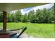 Relaxing covered patio with hammock overlooking a sprawling green lawn, perfect for peaceful outdoor enjoyment at 3659 Vashti Rd, Taylorsville, NC 28681